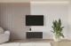 Material: Holzwerkstoff, Material der Rückwand: MDF, Ausführung: Hängend, Größe: 100 cm, Farbe: Weiß und Schwarz, Zimmer: Wohnzimmer, Anzahl der Türen: 2, Front-Typ: Gefräste, Art der Griffe: Griffleiste, Art der Türen: Klapptür, Breite: 100 cm, Tiefe: 40 cm, Höhe: 40 cm, Geschlossene Fächer: 4, Anzahl der Teile: 1 - 1